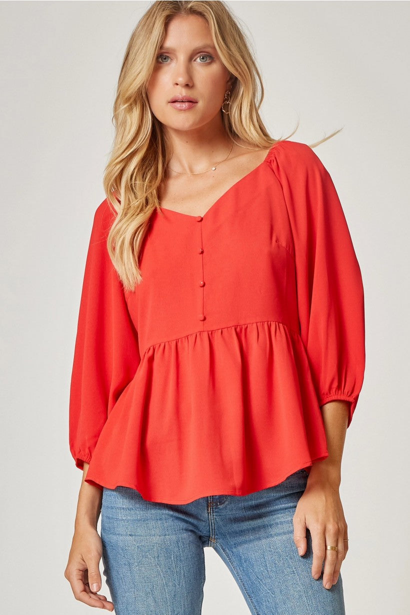 RED PEPLUM WITH BUTTON DETAILS
